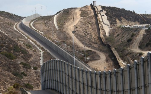 This recent Getty Images file photo shows a section of existing border wall near San Diego, Calif. (PHOTO: america.aljazeera.com)