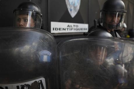 Guatemalan police guard the entrance to the shelter. (PHOTO: ap.org)