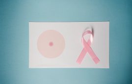 pink ribbon on top of a paper