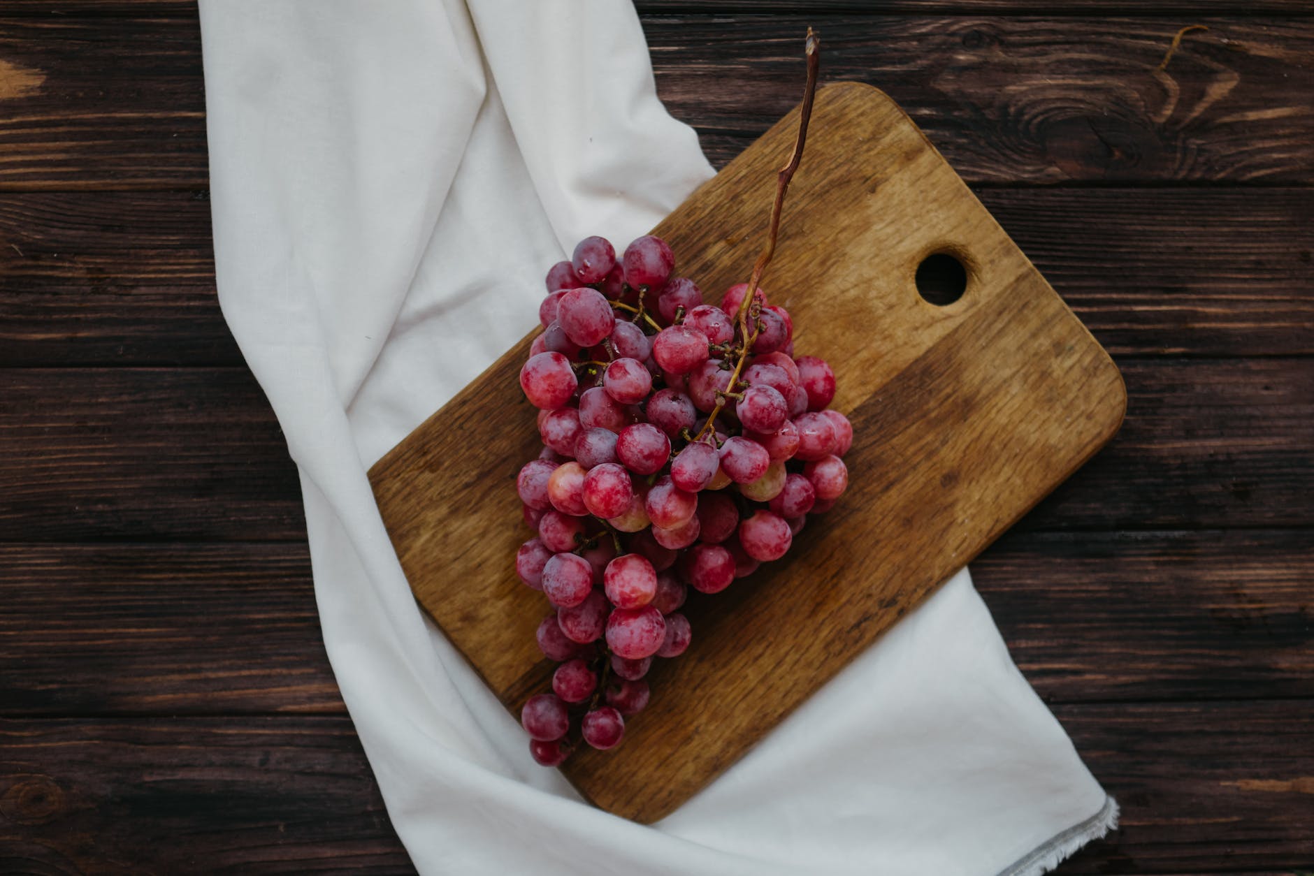 grapes on wooden chopping board
